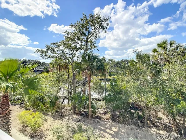 an aerial view of a tennis ground with a white house