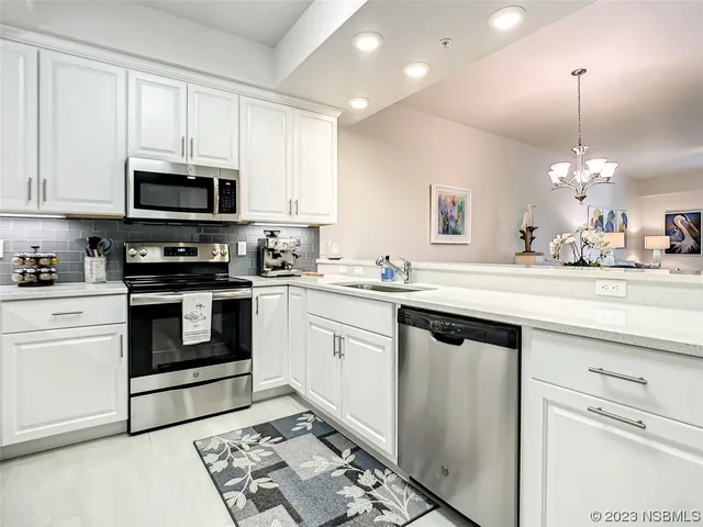 a kitchen with a stove a sink and a refrigerator
