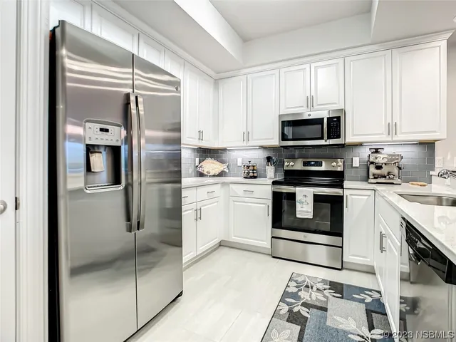 a kitchen with stainless steel appliances refrigerator and cabinets