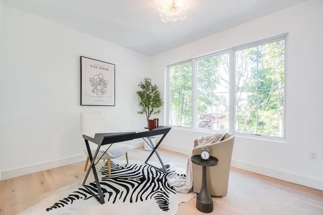 a view of a dining room with furniture and window