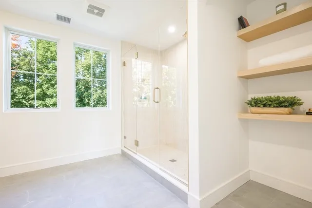 a view of bathroom with bathtub and shower