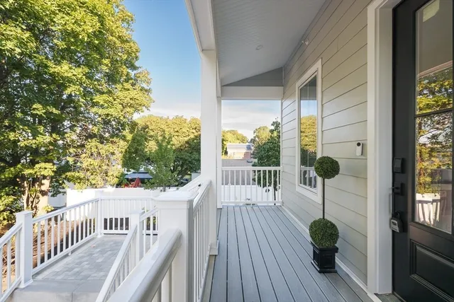 a view of a balcony with wooden floor