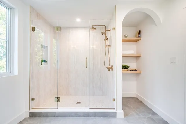 a bathroom with a glass shower door