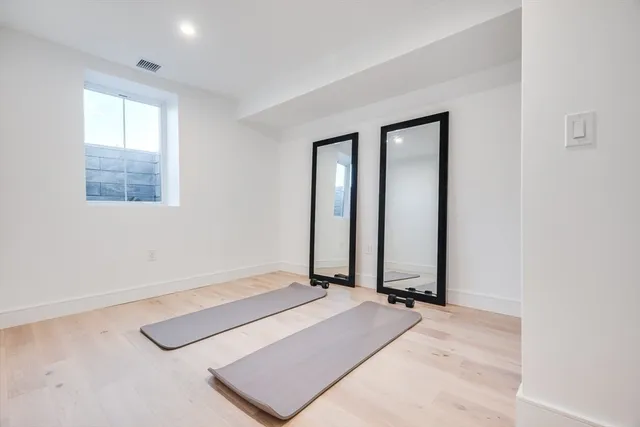 a bathroom with a bathtub shower sink vanity mirror and toilet