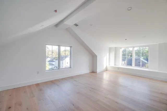 a bathroom with a toilet a sink a mirror and vanity