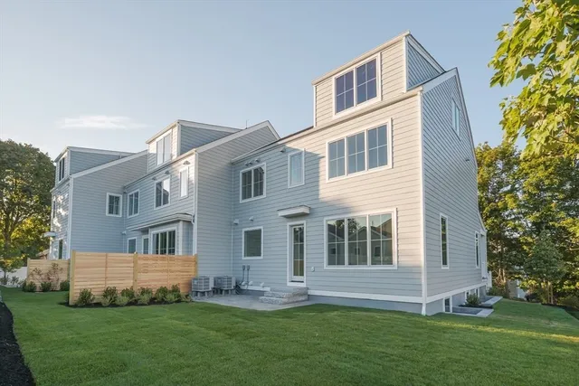 a view of a big house with a big yard and potted plants