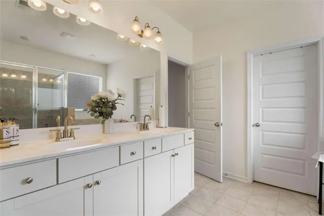 a bathroom with a sink vanity and mirror