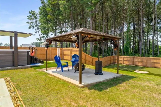 a view of swimming pool with sitting area and garden