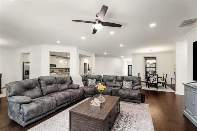 a living room with furniture and wooden floor