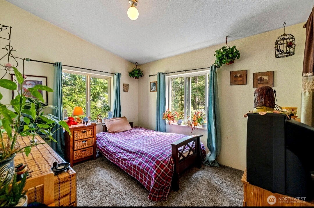 42041 Cedar Street Concrete, WA 98237 - Photo 23 of 33 a bedroom with a bed and wooden floor
