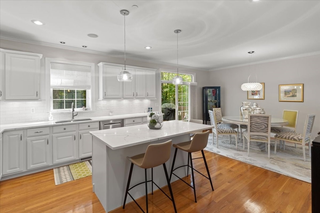 923 Lagrange Street, Unit 923 Boston, MA 02132 - Photo 15 of 32 a kitchen with center island table and chairs in it