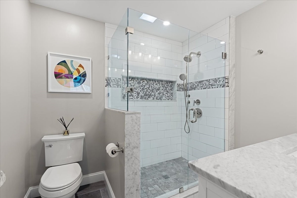 923 Lagrange Street, Unit 923 Boston, MA 02132 - Photo 22 of 32 a bathroom with a sink a toilet and shower