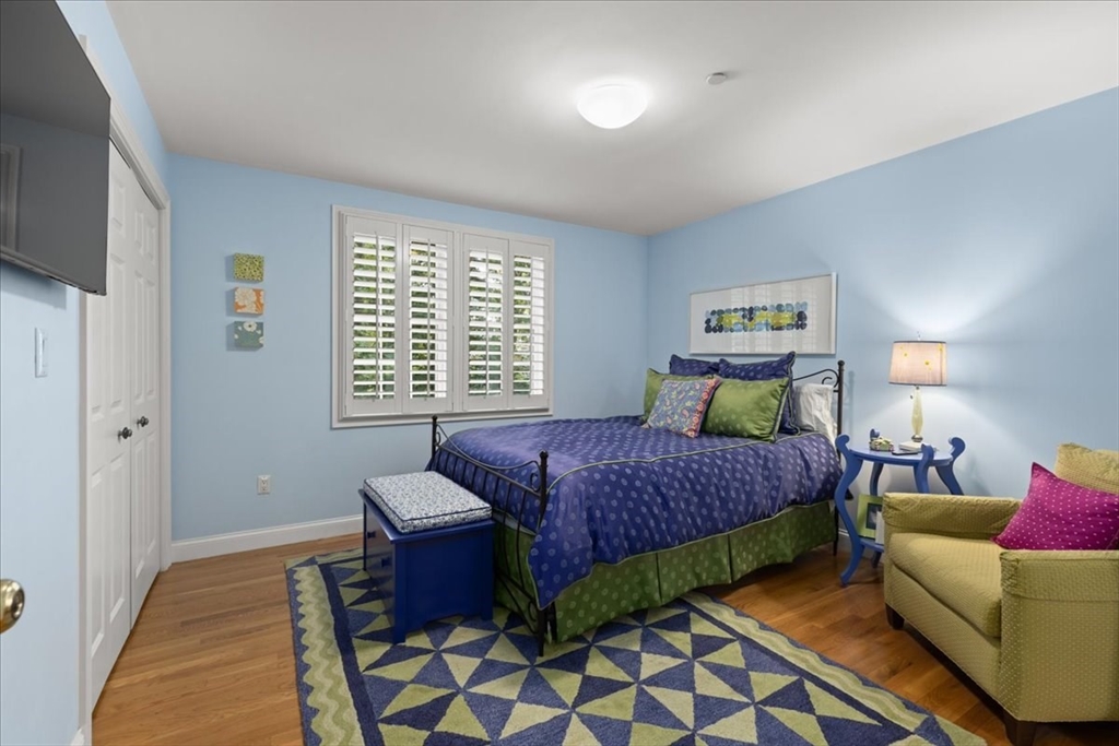 923 Lagrange Street, Unit 923 Boston, MA 02132 - Photo 24 of 32 a bedroom with a bed and a couch