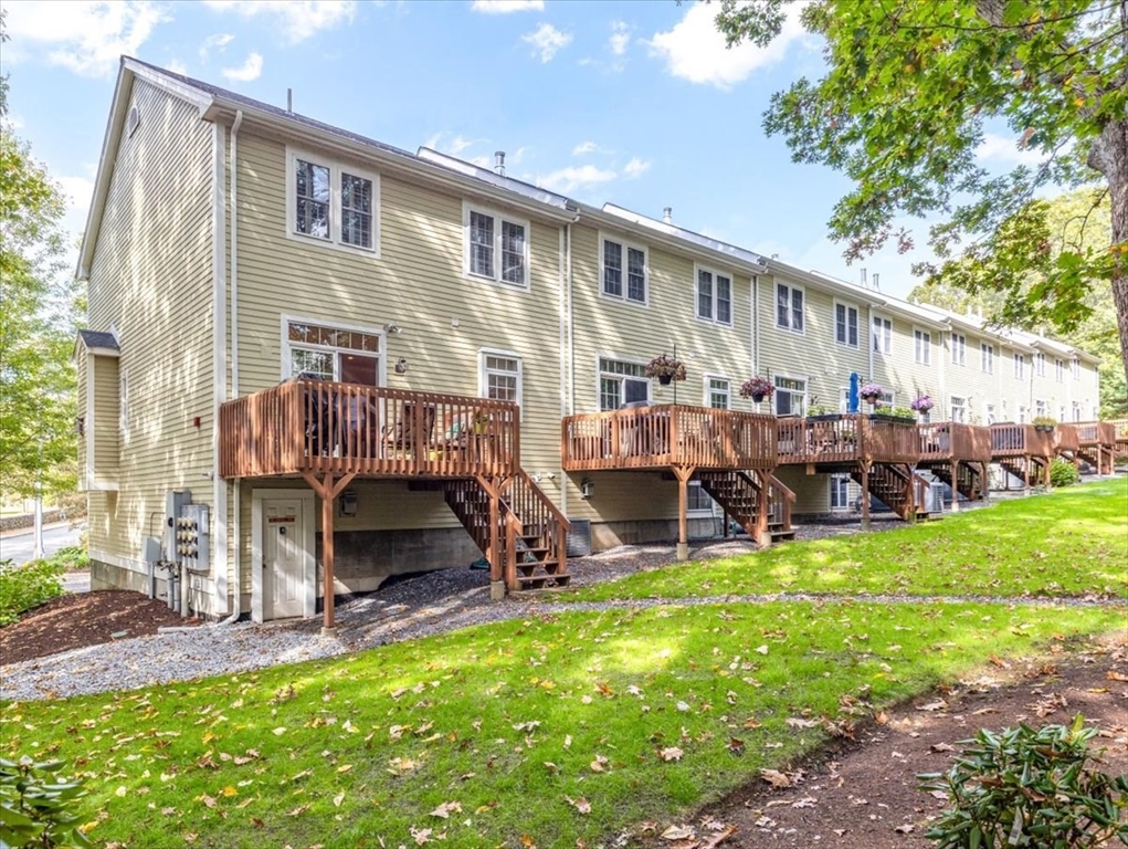 923 Lagrange Street, Unit 923 Boston, MA 02132 - Photo 31 of 32 a view of a house with a patio and a yard