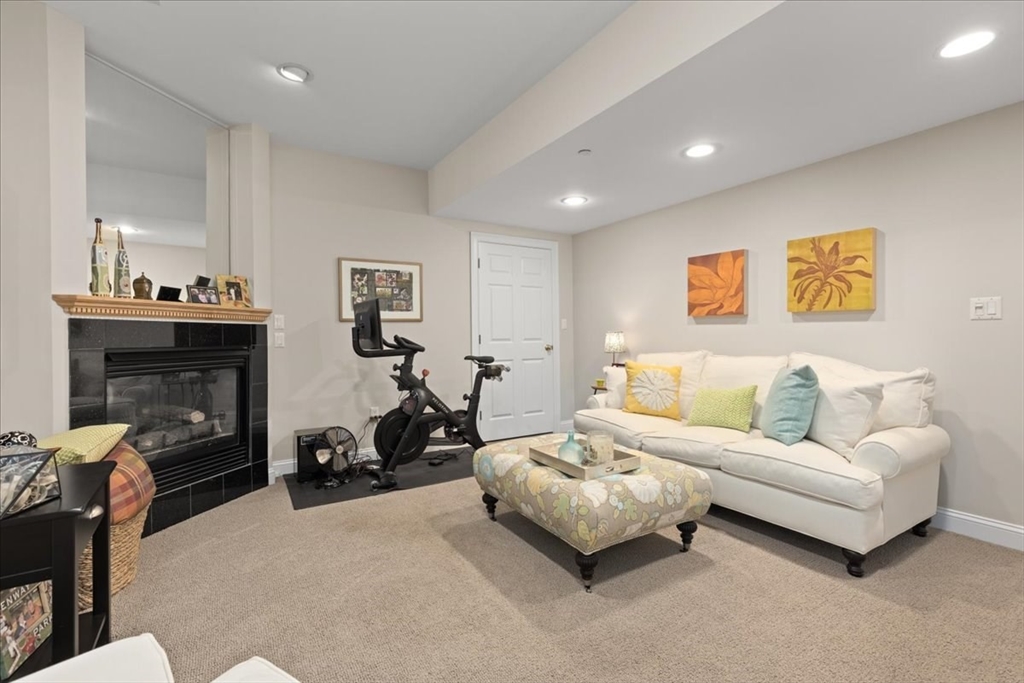 923 Lagrange Street, Unit 923 Boston, MA 02132 - Photo 6 of 32 a bedroom with furniture and a fireplace