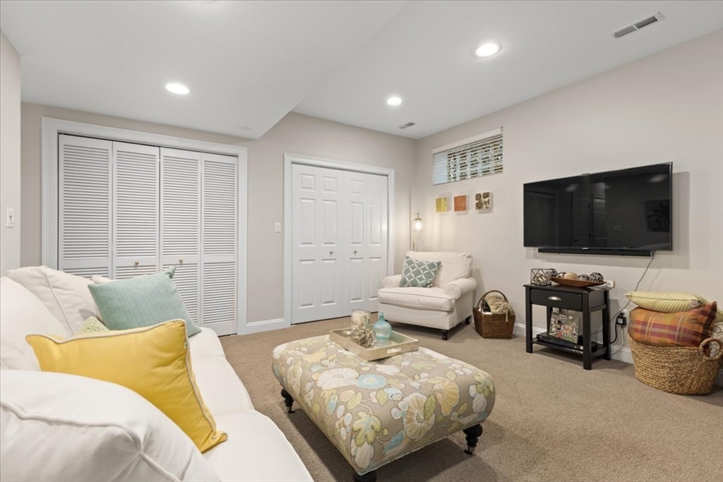 923 Lagrange Street, Unit 923 Boston, MA 02132 - Photo 7 of 32 a living room with furniture and a flat screen tv