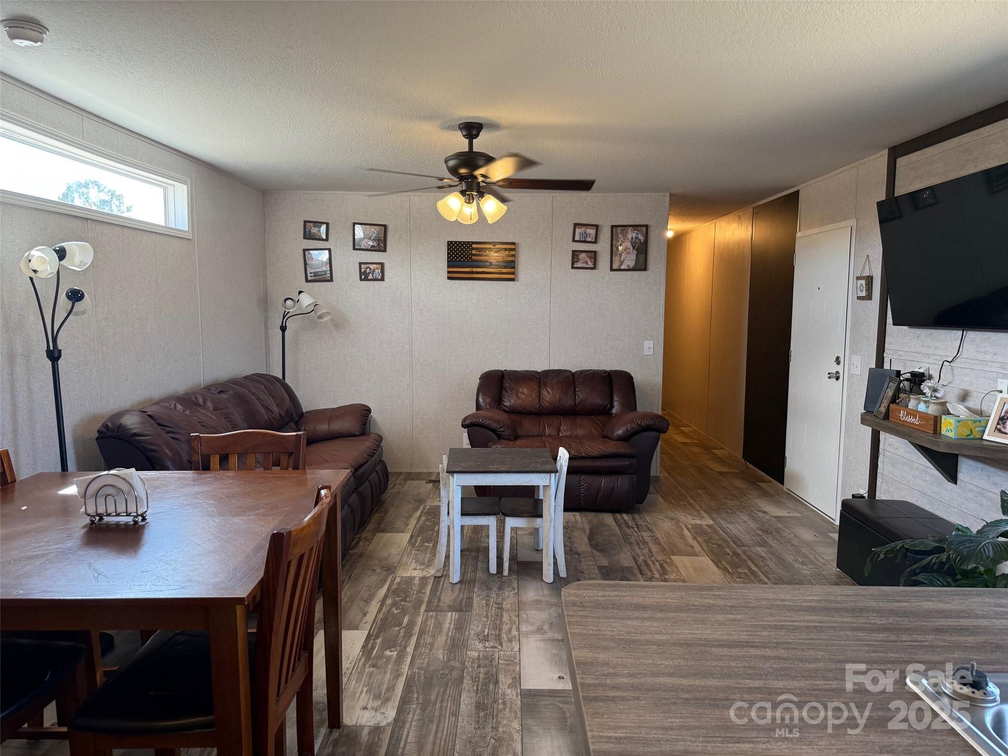 891 Longbranch Road Jefferson, SC 29718 - Photo 15 of 21 a work room with furniture a flat screen tv and a table