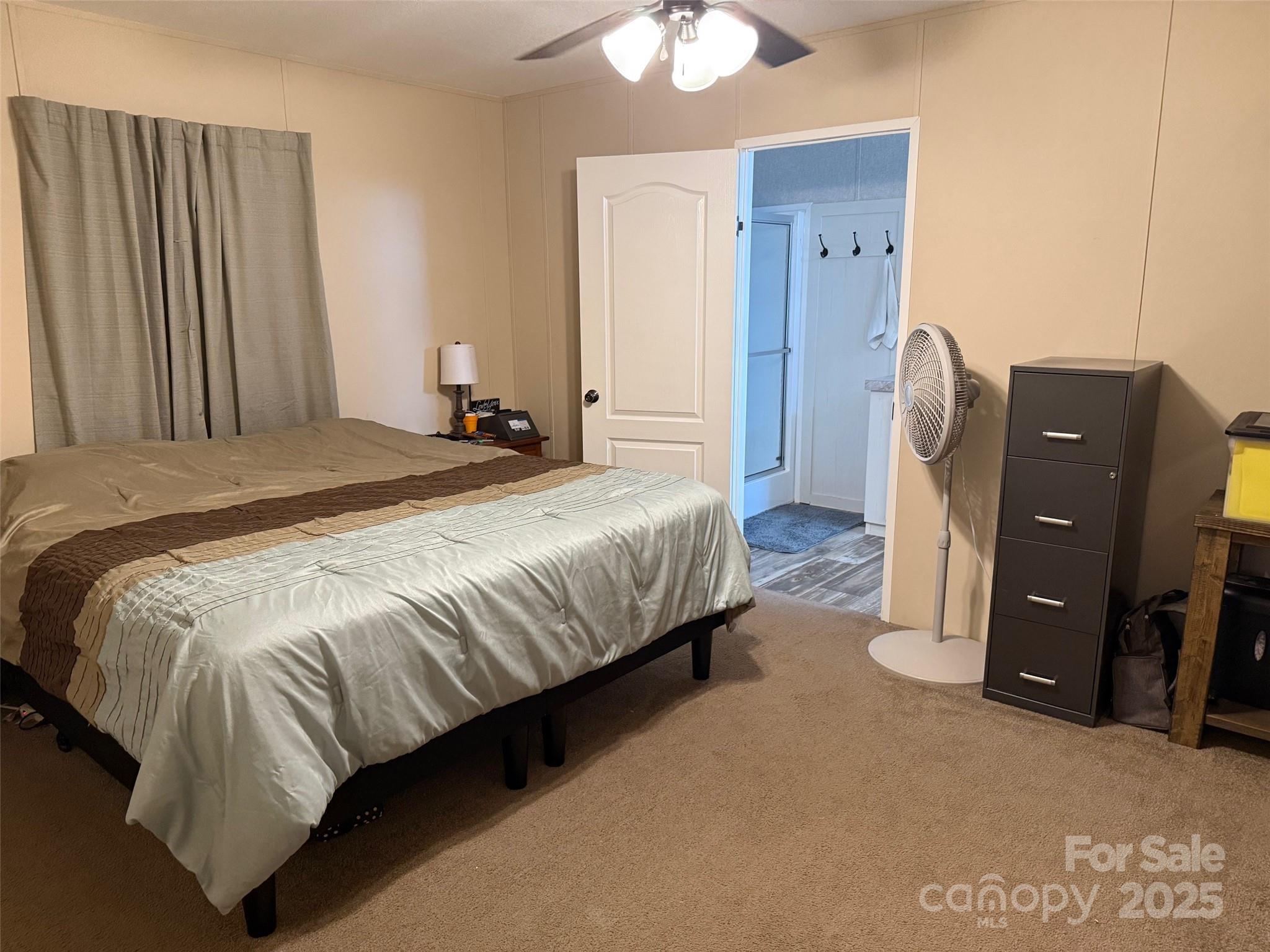 891 Longbranch Road Jefferson, SC 29718 - Photo 17 of 21 a bedroom with a bed and dresser with mirror