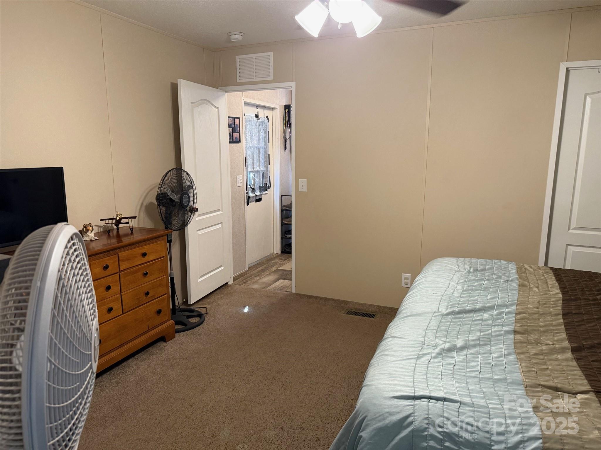 891 Longbranch Road Jefferson, SC 29718 - Photo 18 of 21 a bedroom with a bed and a chandelier