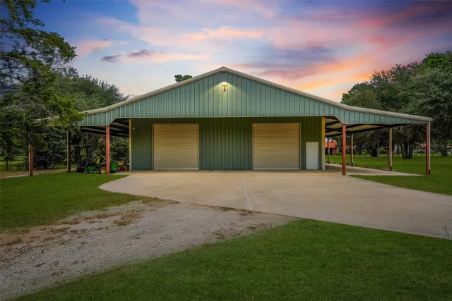 a front view of a house with a yard and trees