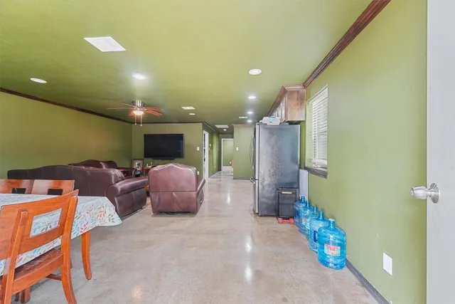 a view of a dining room with furniture and a window