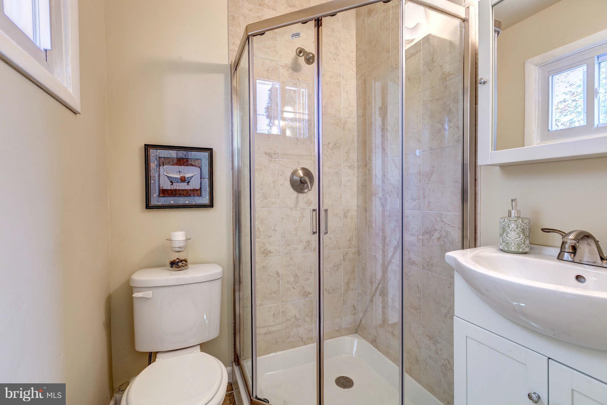 3702 Pinelea Road Baltimore, MD 21244 - Photo 14 of 29 a bathroom with a sink a toilet and shower