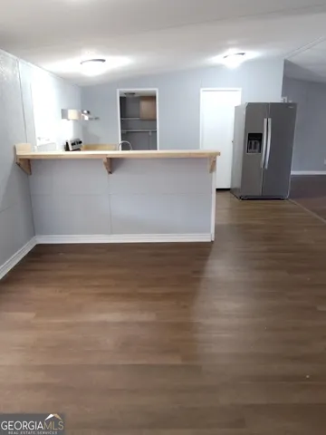 a view of a kitchen with cabinets and wooden floor