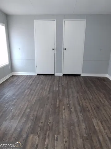 a view of a room with wooden floor and window