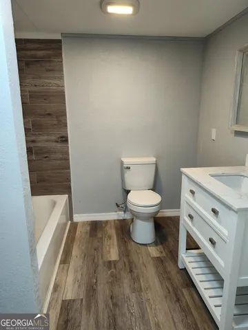 a bathroom with a toilet and a bathtub