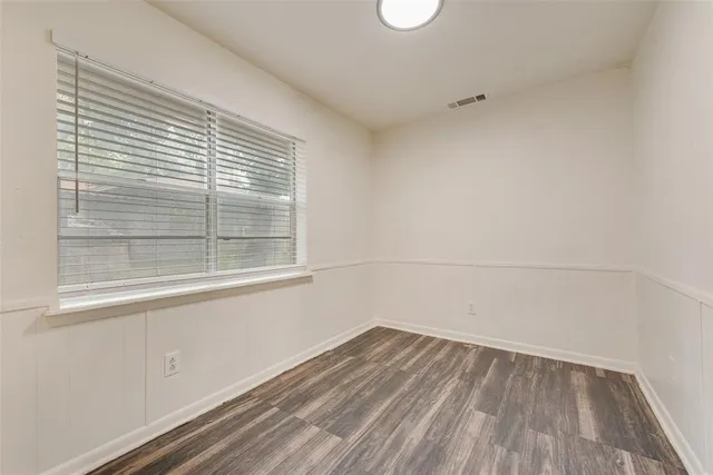 a view of a room with wooden floor and windows