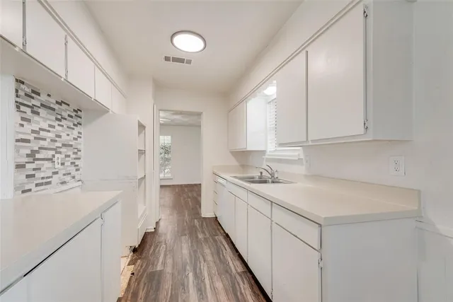 a kitchen with a sink stove and cabinets