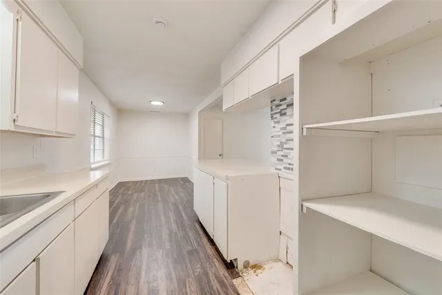 a view of hallway with wooden floor and staircase