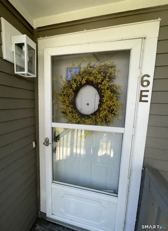 a bathroom with a wooden floor and mirror