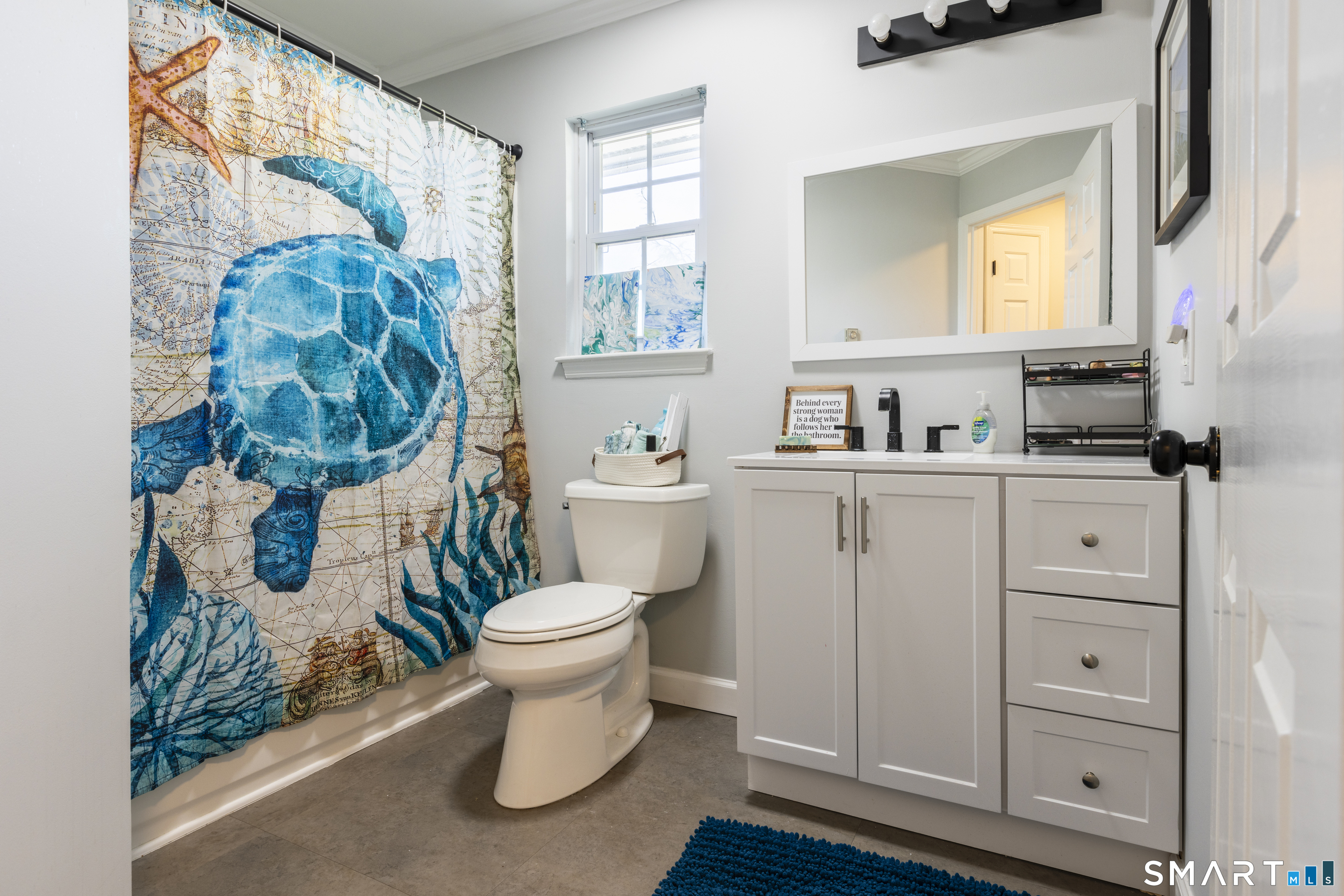 53 Brushy Plain Road, Unit 6E Branford, CT 06405 - Photo 11 of 13 a bathroom with a toilet sink and mirror