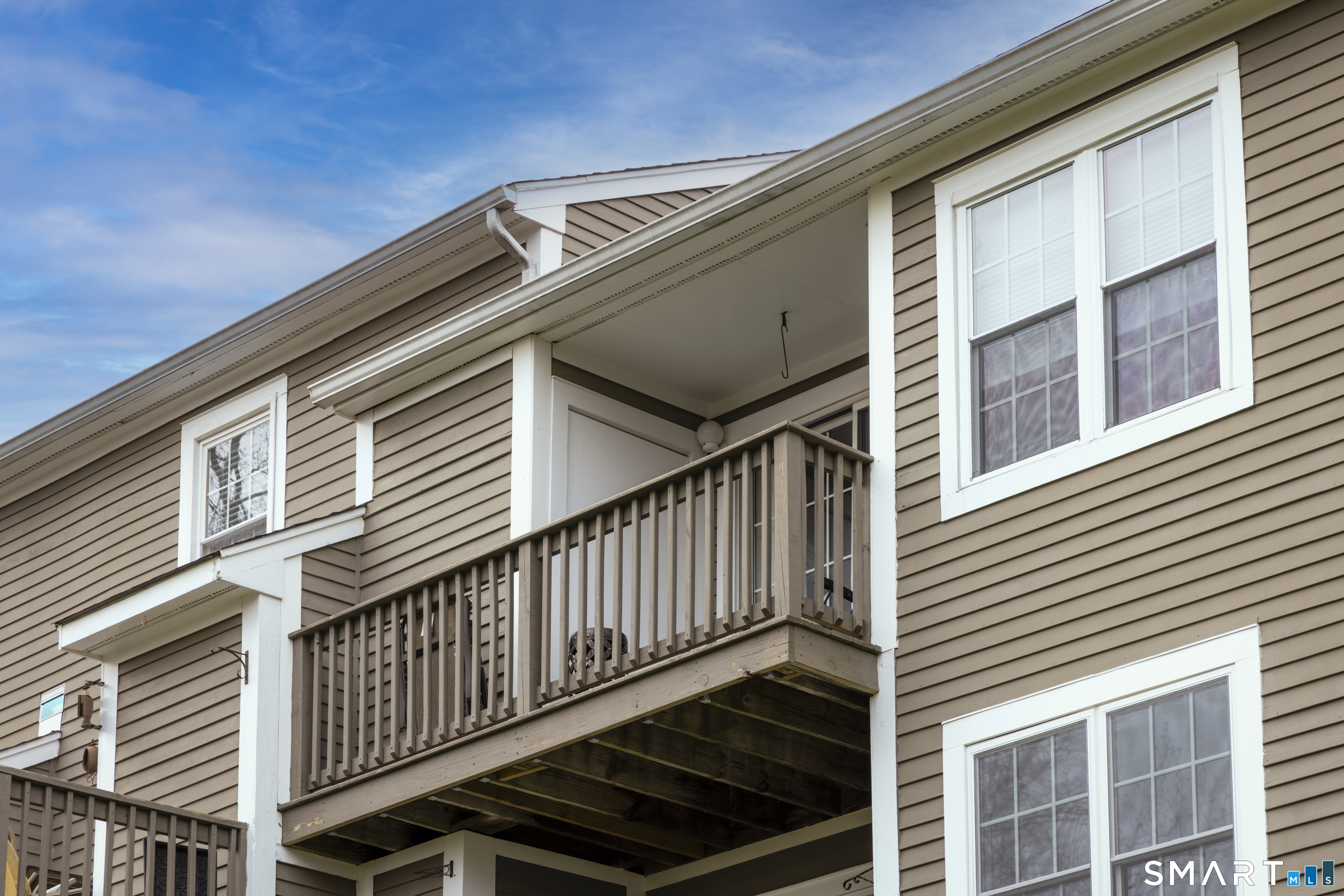 53 Brushy Plain Road, Unit 6E Branford, CT 06405 - Photo 13 of 13 a front view of a house with wooden stairs