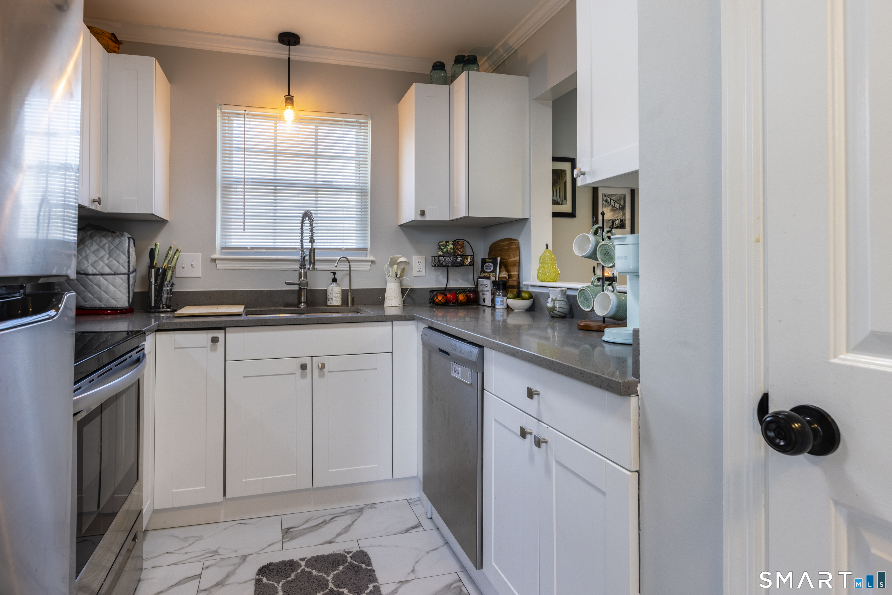 53 Brushy Plain Road, Unit 6E Branford, CT 06405 - Photo 3 of 13 a kitchen with white cabinets and sink