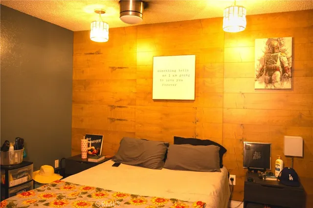 a bedroom with a bed and a flat screen tv