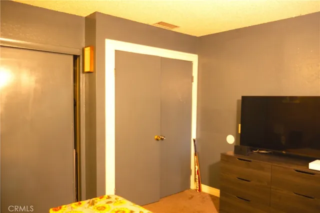 a view of a workspace with furniture and a flat screen tv