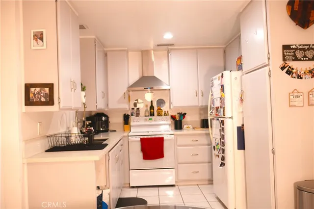 a kitchen with a sink stove and refrigerator