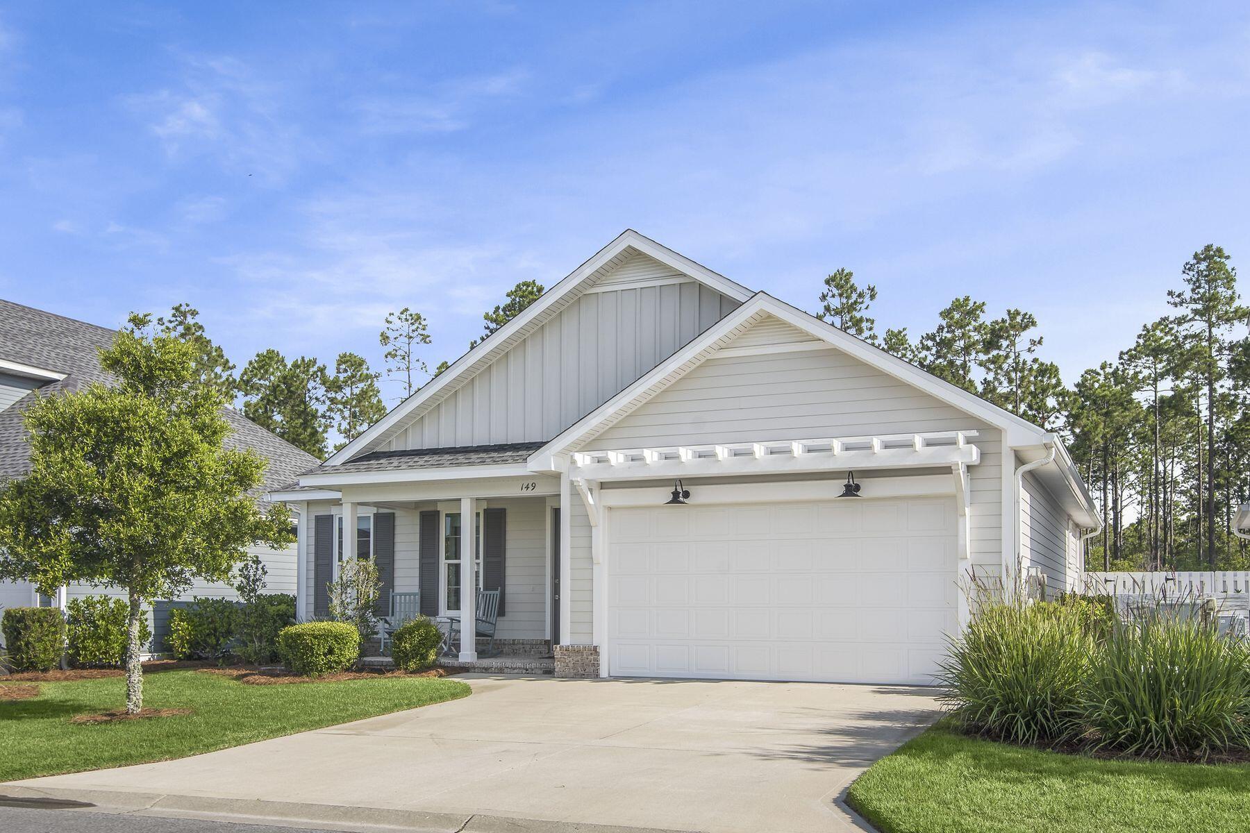 149 Windrow Way Watersound, FL 32461 - Photo 2 of 27 a front view of a house with a yard and garage