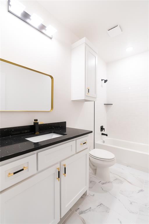 839 Southwest 7th Street Cooper, TX 75432 - Photo 21 of 21 Bathroom with washtub / shower combination, marble finish floor, toilet, and vanity
