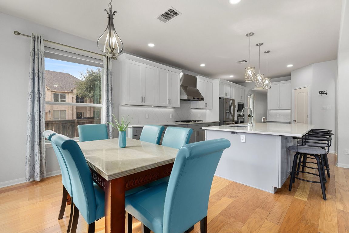 701 Old Ravine Court Round Rock, TX 78665 - Photo 9 of 40 Dining area featuring light wood-style flooring and recessed lighting