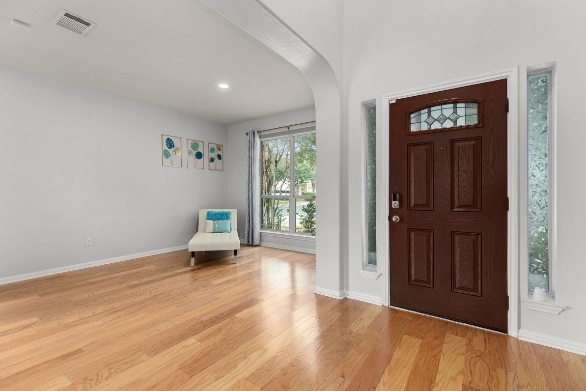701 Old Ravine Court Round Rock, TX 78665 - Photo 13 of 40 Foyer entrance with light wood-type flooring, arched walkways, and recessed lighting