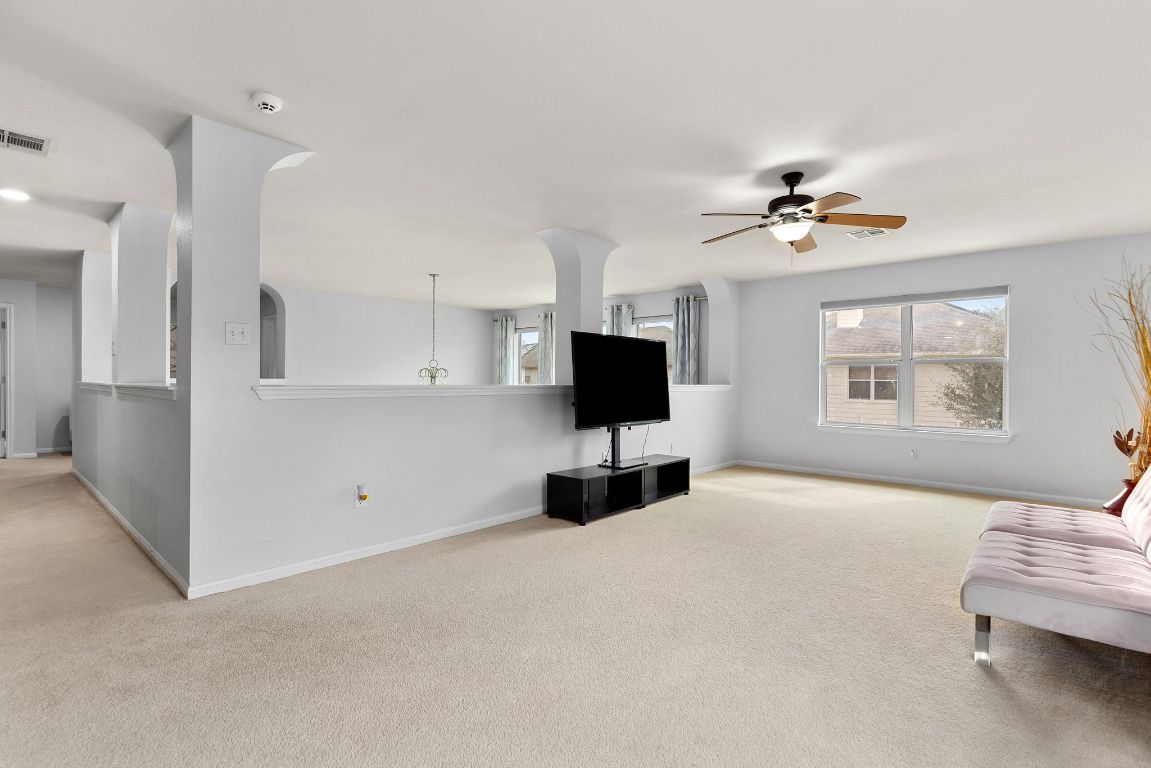 701 Old Ravine Court Round Rock, TX 78665 - Photo 21 of 40 Living room with light carpet and a ceiling fan