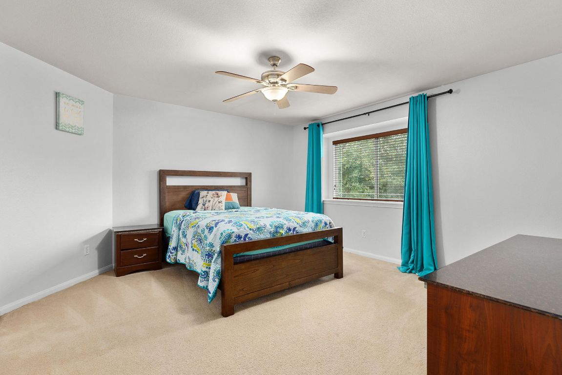 701 Old Ravine Court Round Rock, TX 78665 - Photo 29 of 40 Bedroom featuring light colored carpet and ceiling fan