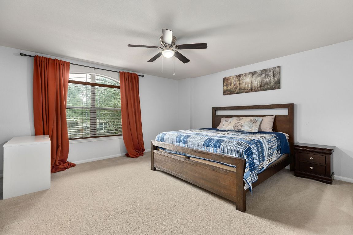 701 Old Ravine Court Round Rock, TX 78665 - Photo 30 of 40 Bedroom featuring ceiling fan and carpet