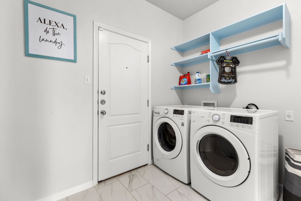 701 Old Ravine Court Round Rock, TX 78665 - Photo 33 of 40 Laundry area with washing machine and dryer and light marble finish floors