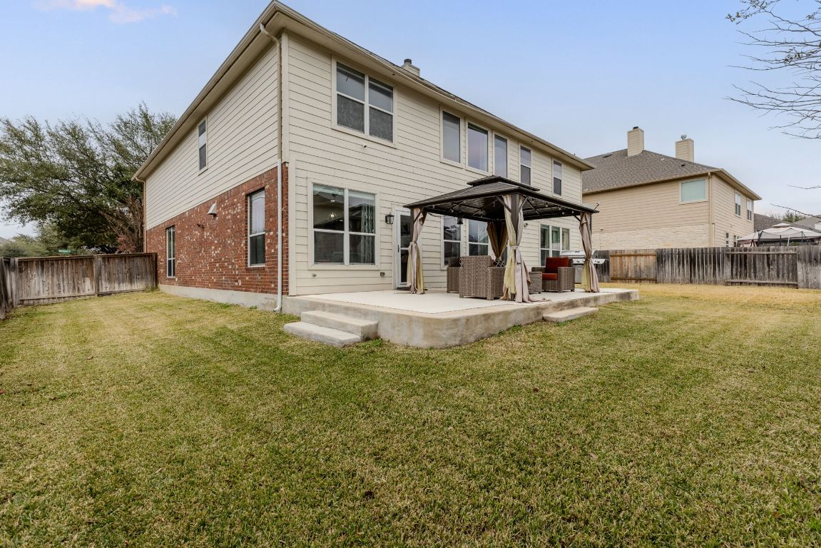 701 Old Ravine Court Round Rock, TX 78665 - Photo 34 of 40 Back of property featuring a gazebo, a fenced backyard, a patio, and brick siding
