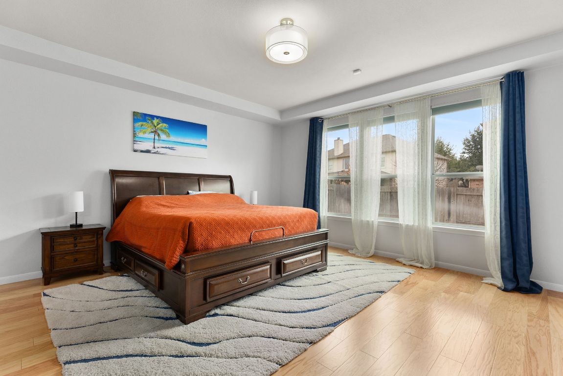 701 Old Ravine Court Round Rock, TX 78665 - Photo 4 of 40 Bedroom featuring light wood-style floors and baseboards