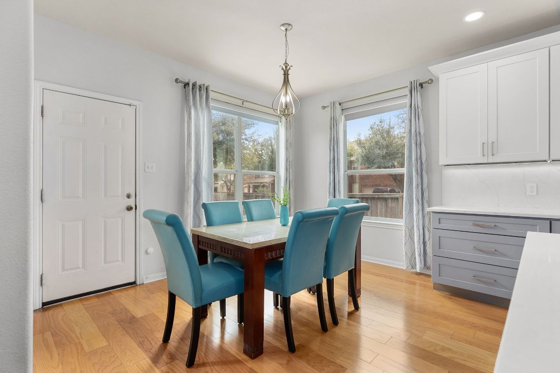 701 Old Ravine Court Round Rock, TX 78665 - Photo 8 of 40 Dining room featuring light wood-type flooring and plenty of natural light